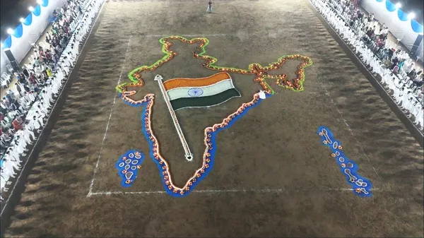 Aerial night photo of a ground with a map of India and flag made of lamps, with rows of students in white on both sides. - Bhavan's BVM SKN