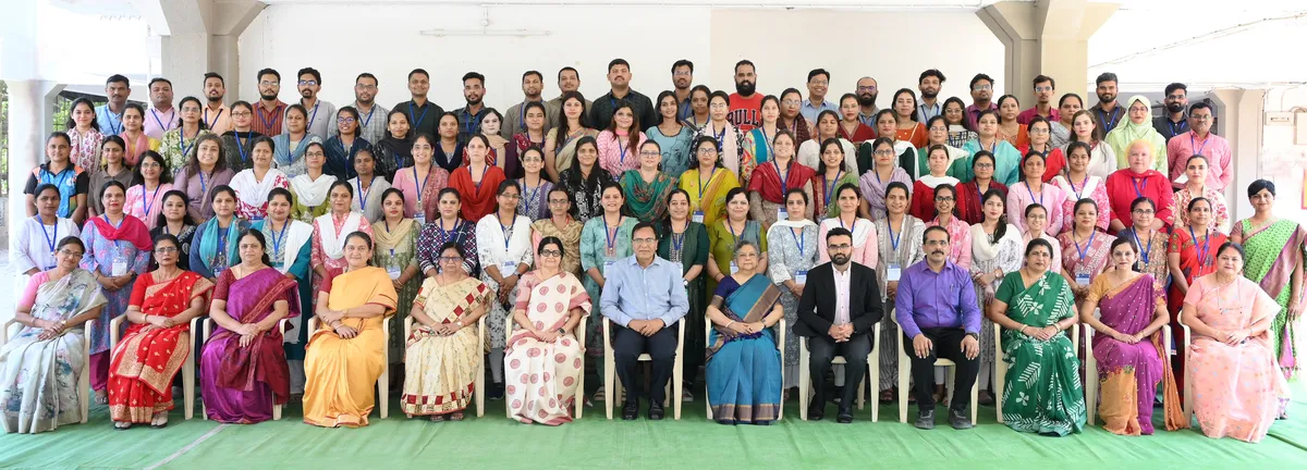 Large group photo of about 80 adults in rows at Bhavan's BVM SKN induction training programme