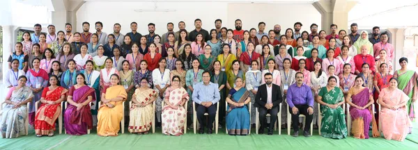 Large group photo of about 80 adults in rows at Bhavan's BVM SKN induction training programme