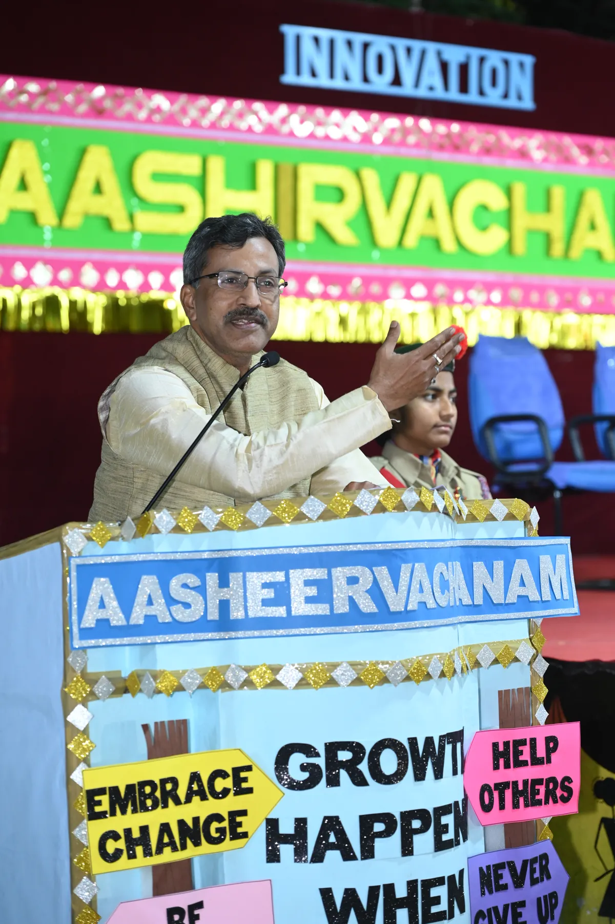 Chief Guest speaking at decorated podium during Aashirvachanam ceremony at Bhavan's BVM SKN