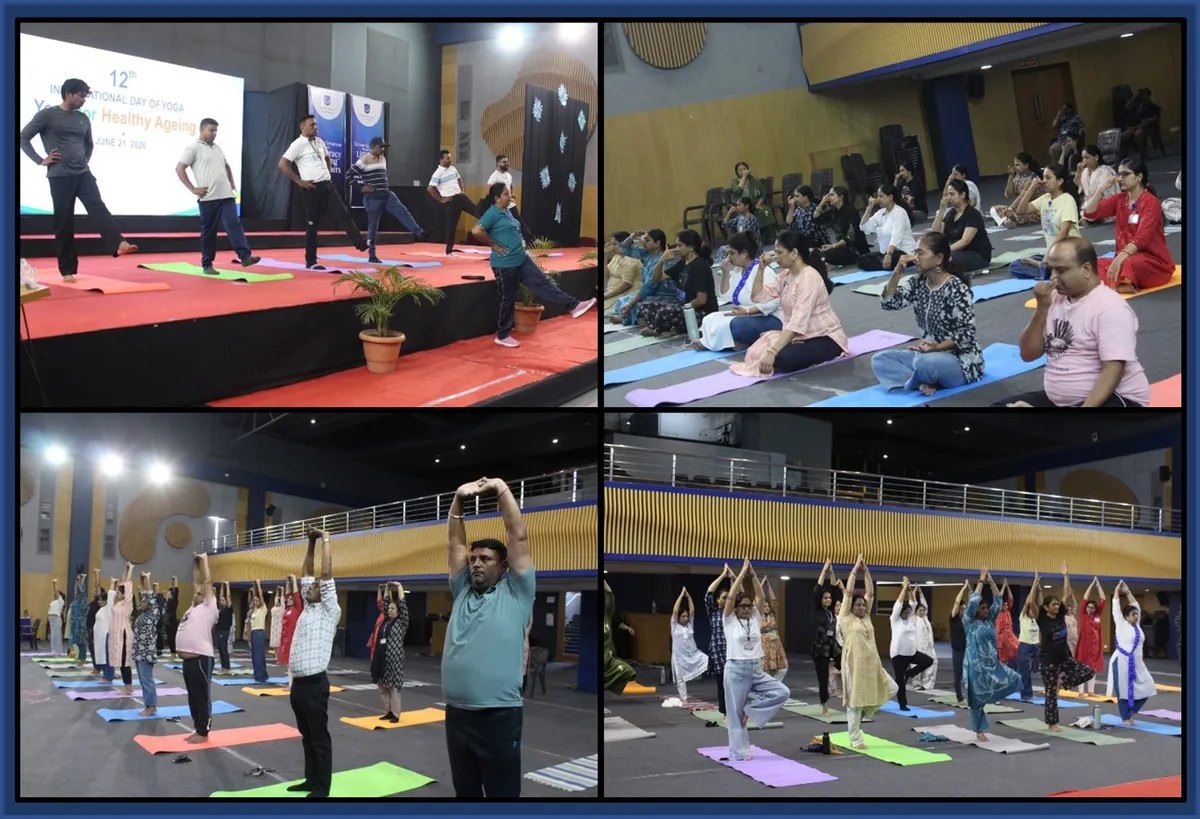 CPS (Katol Road): staff doing yoga on mats in a hall with instructors on stage and a projected slide.