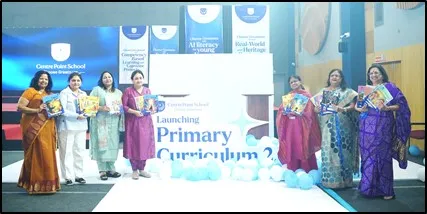 Women in sarees and formal wear stand on stage holding books at the launch of Primary Curriculum 2.0, CPS (Katol Road)