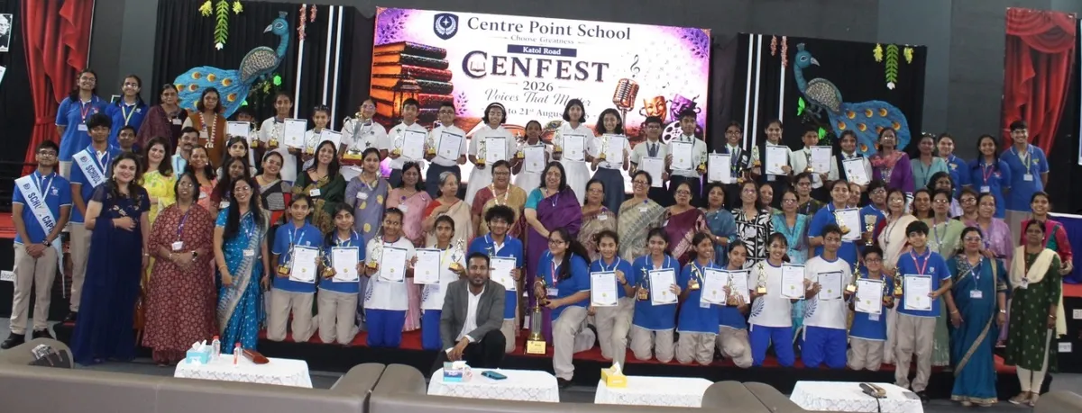 Group photo of students and teachers on stage with certificates and trophies at CENFEST 2026 festival backdrop.
