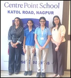 Four people, two adults and two students in blue uniforms, standing in front of CPS (Katol Road) backdrop.