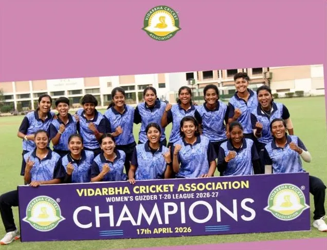 Group photo of women cricketers in blue jerseys with a champions banner at CPS (Katol Road)