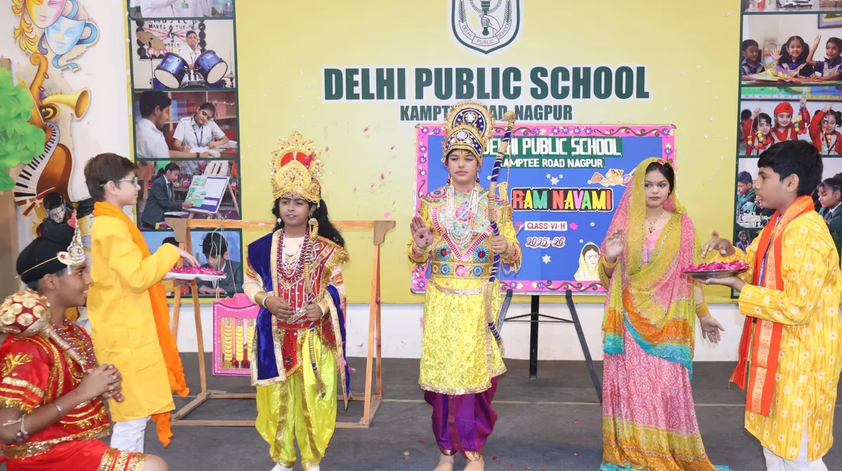 Students in traditional costumes performing a Ram Navami skit on a school stage, with a decorated board and DPS (Kamptee Road) name banner behind them.