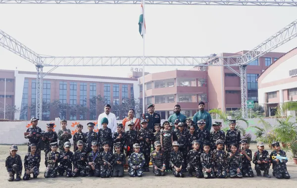 Group photo of young children in uniforms with adults and flagpole at DPS (Kamptee Road)