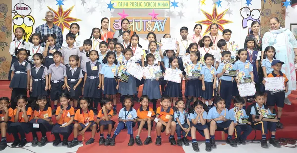 Group photo of many students and teachers on a stage holding certificates and small trophies under a decorated banner at DPS (Mihan).