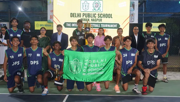 Group photo of basketball players in DPS jerseys with officials, holding a trophy and a green banner on a court. - DPS (Mihan)