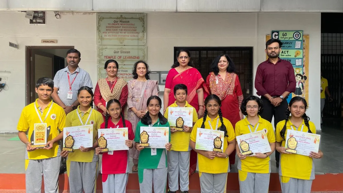 Group photo of eight students holding certificates and trophies, standing in front of six adults outside a school building.